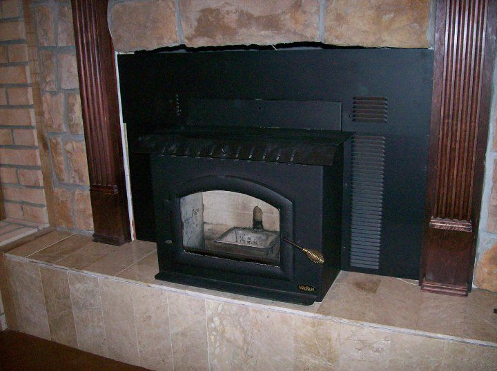 A fireplace with a wood stove built into it