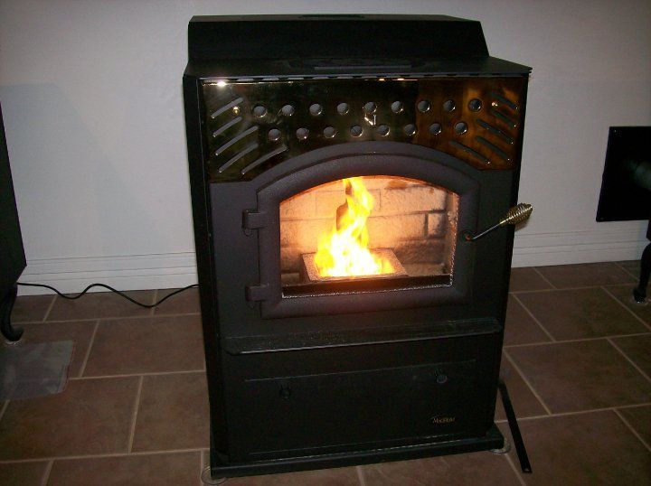 A black stove with a fire coming out of it