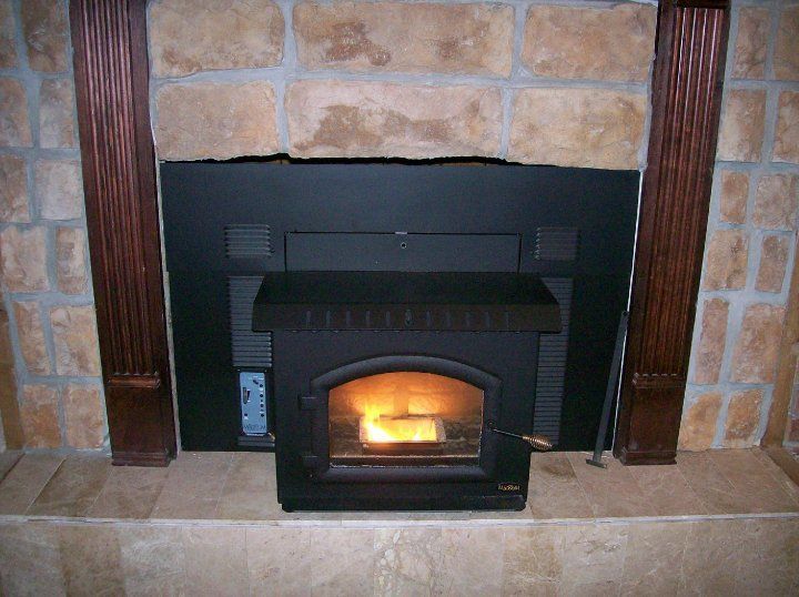 A fireplace with a wood stove built into it