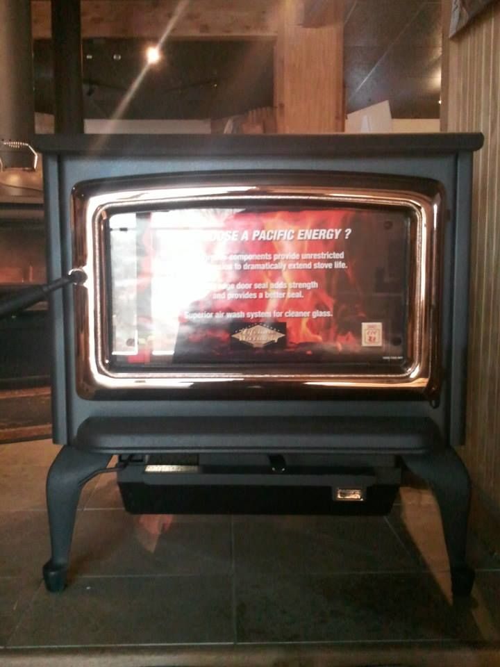 A wood stove with a sign on it that says pacific energy