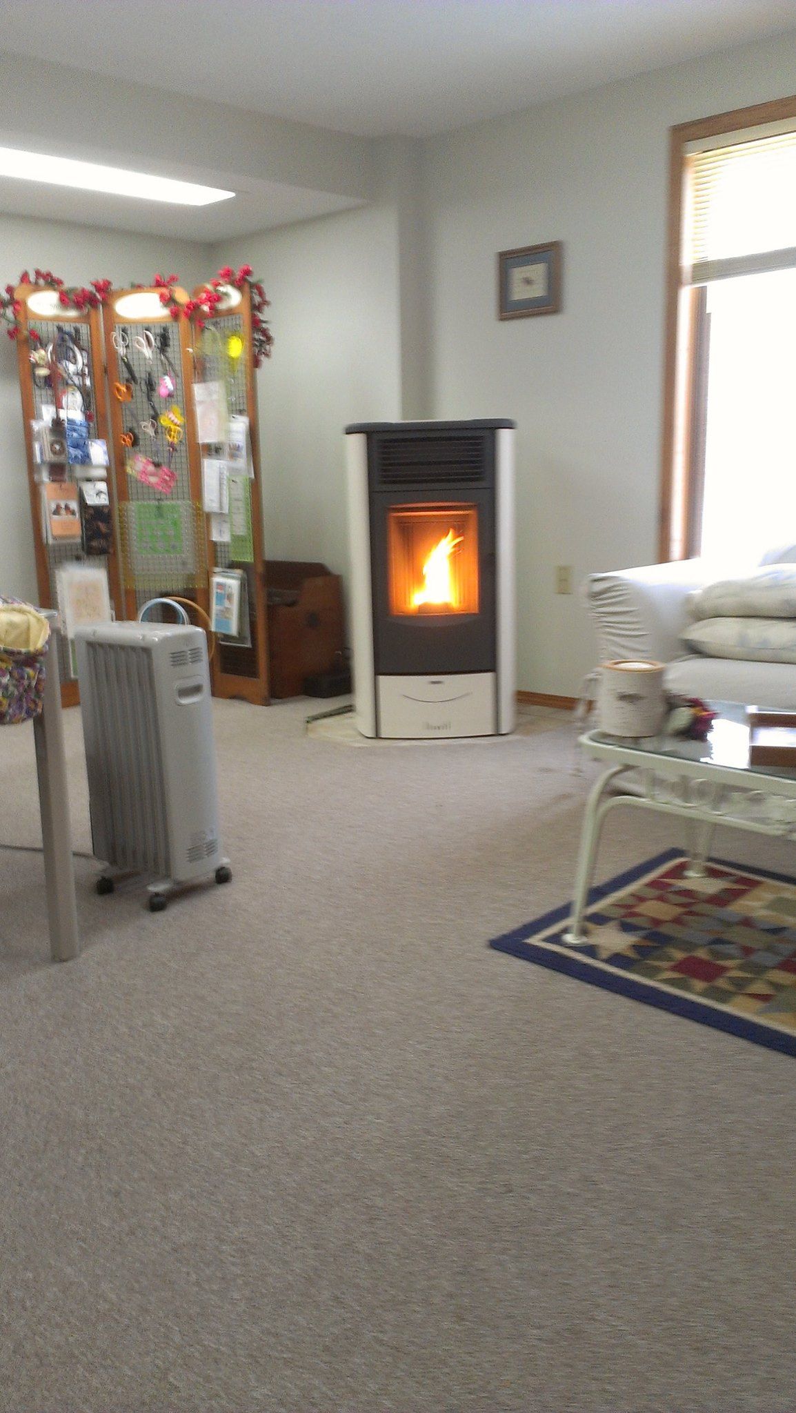 A living room with a wood stove in the corner.