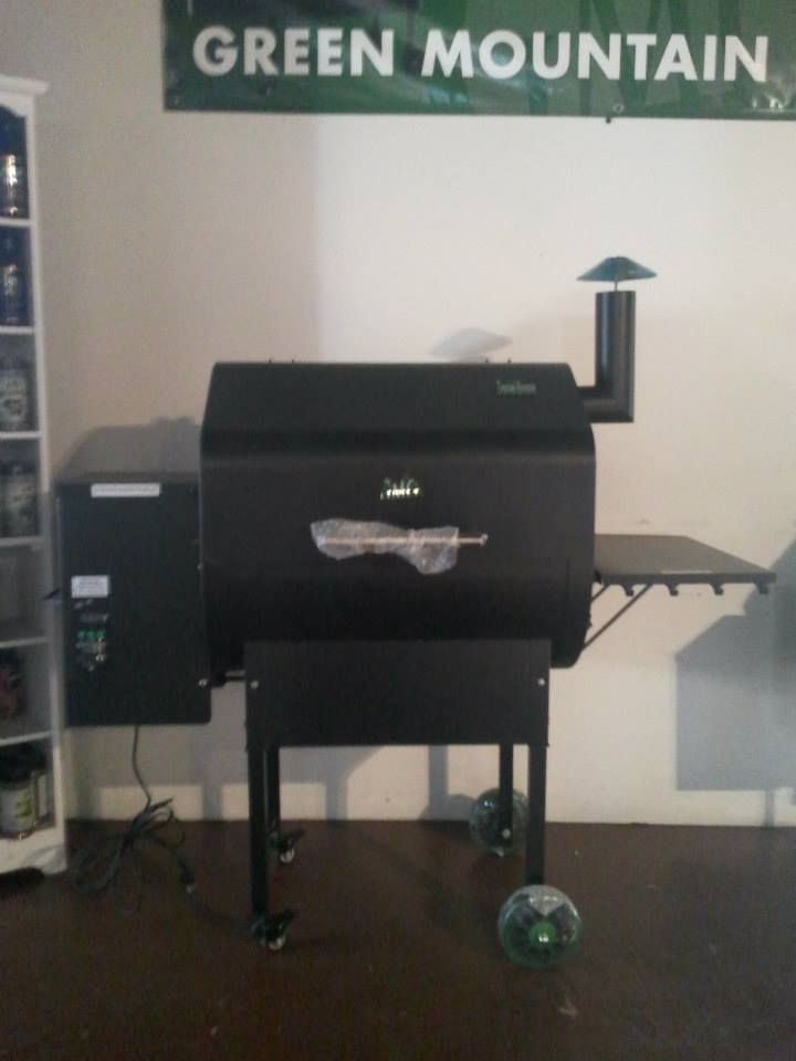 A green mountain sign hangs above a grill