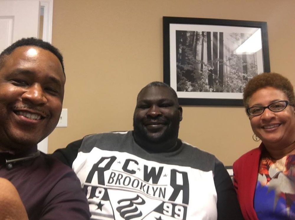 Brian D. Poe, Esq. with his happy clients