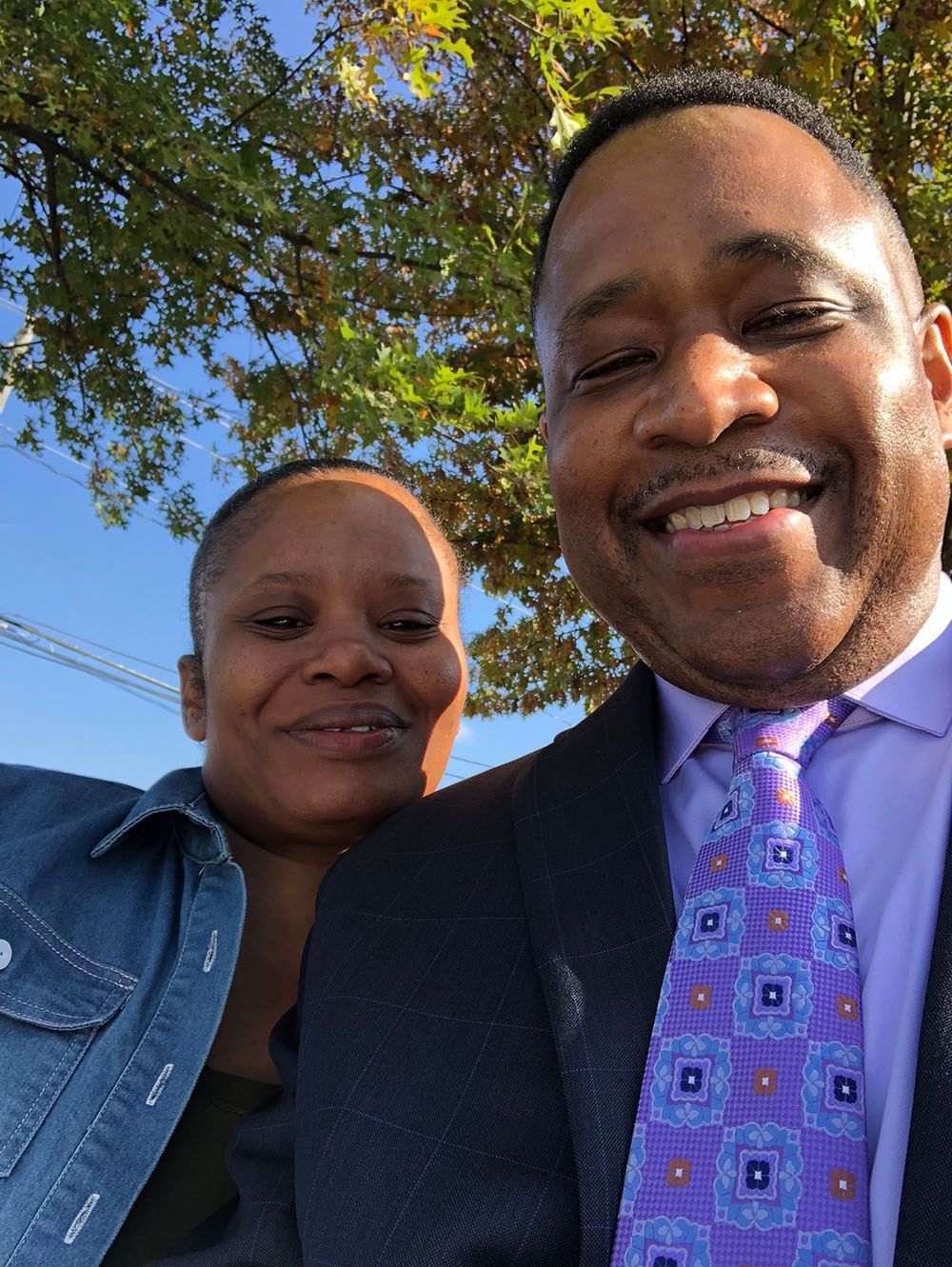 Brian D. Poe, Esq. is standing next to a happy client