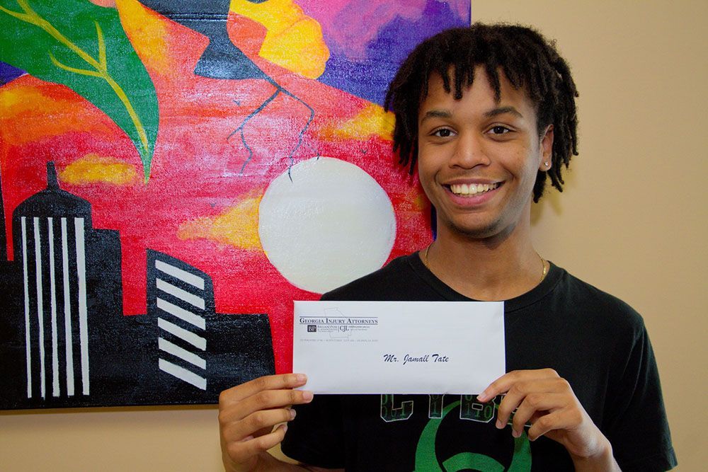 A young man is holding an envelope