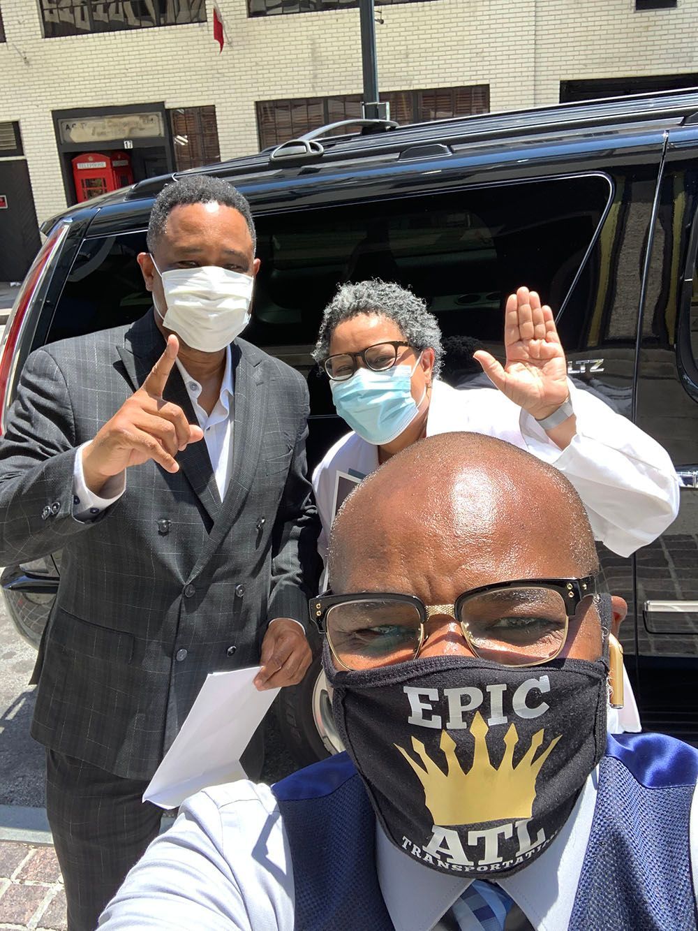 Brian D. Poe, Esq. and his clients wearing face masks