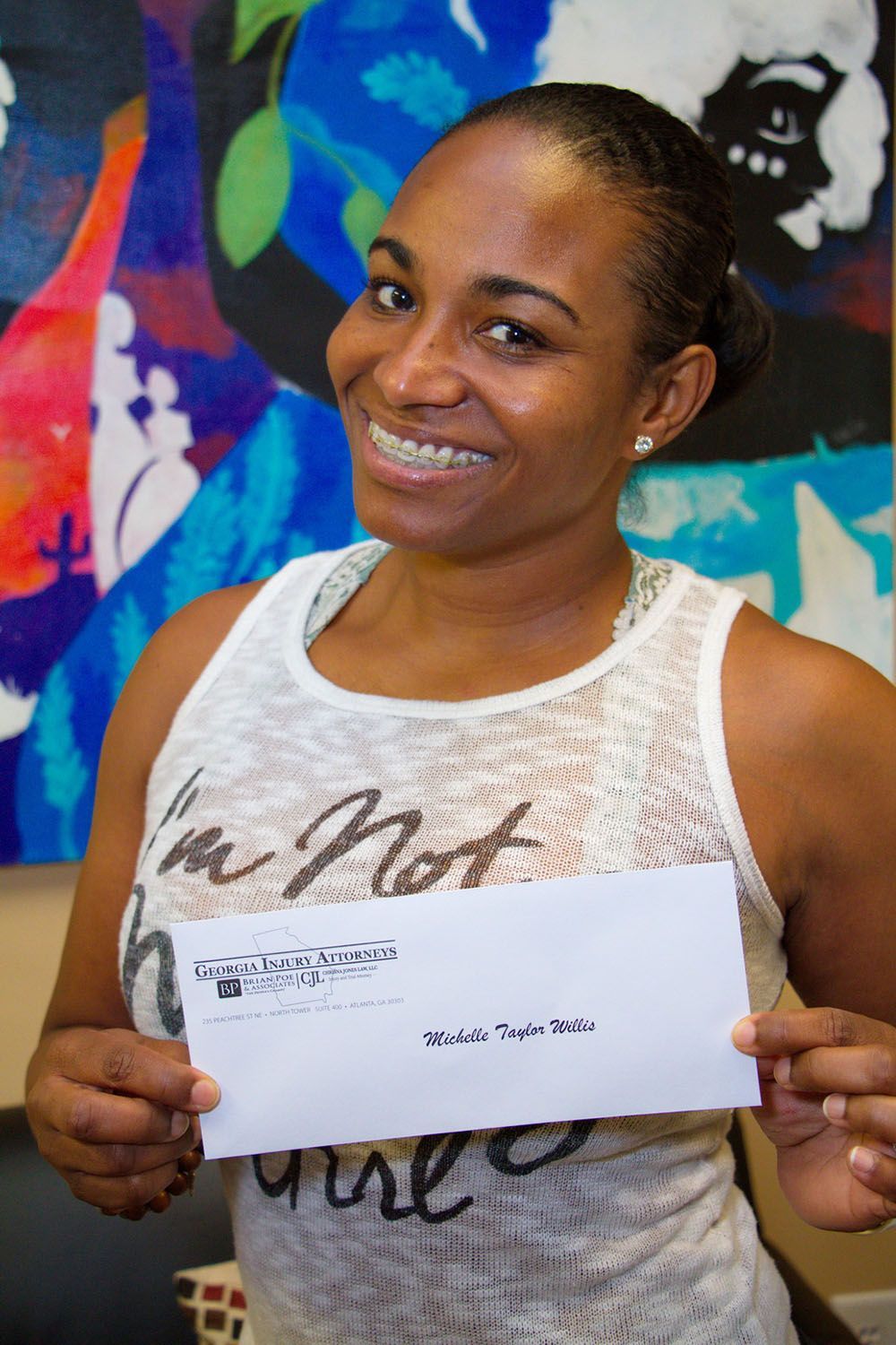 A happy woman holding a check