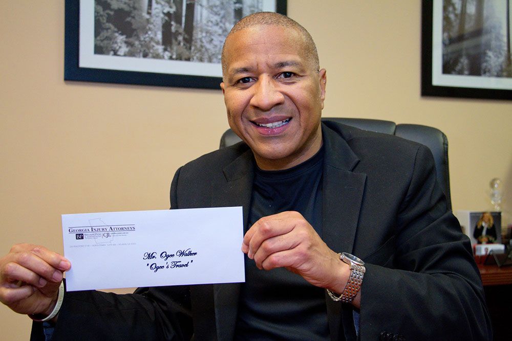A man in a suit is holding an envelope