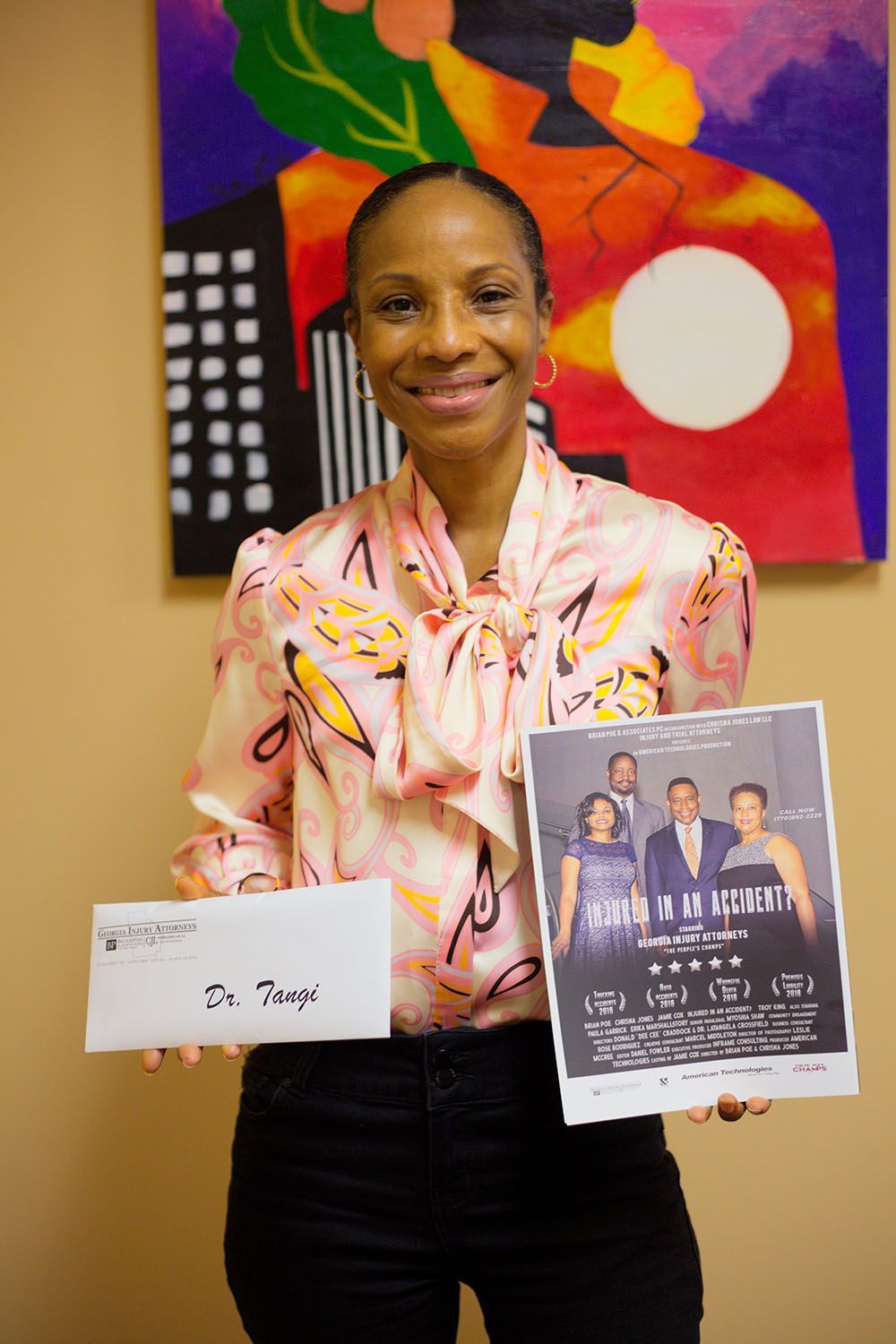 A happy client holding a flyer and a check