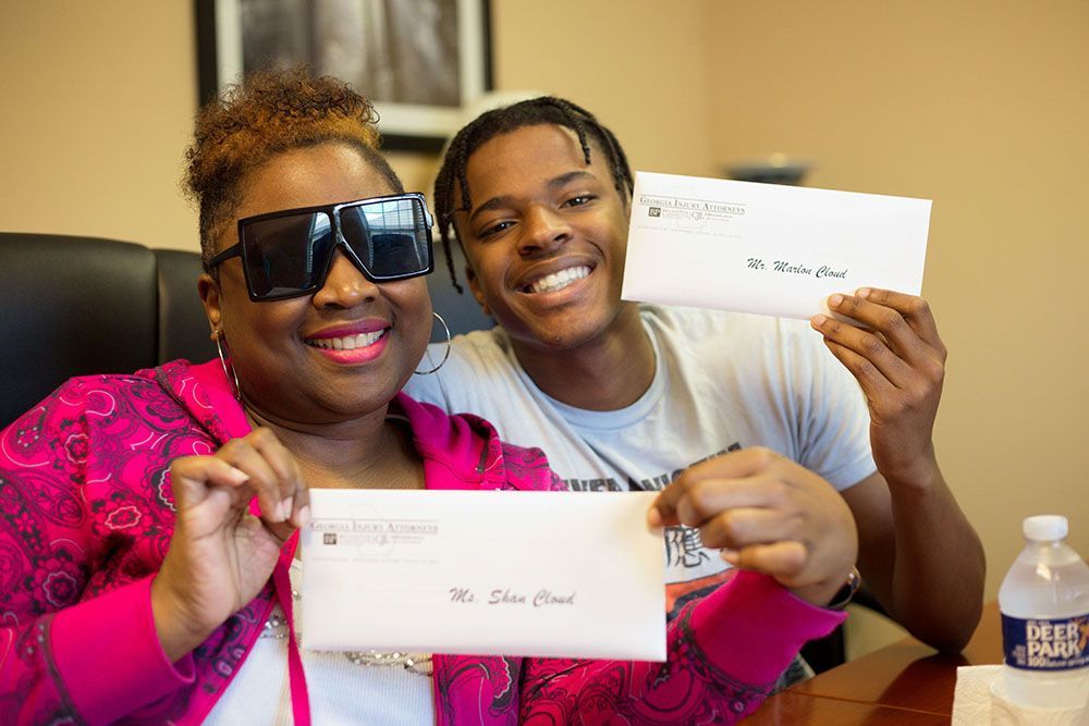A woman and a man are holding envelopes in their hands