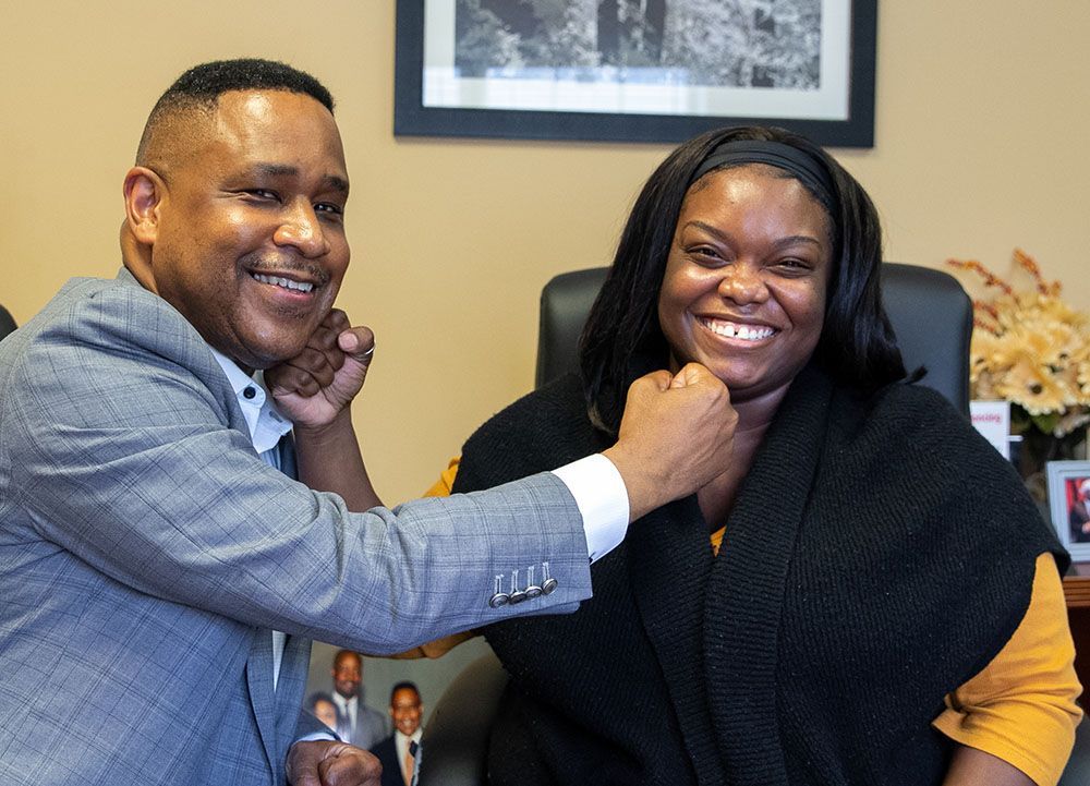 Brian D. Poe, Esq. and a happy female client