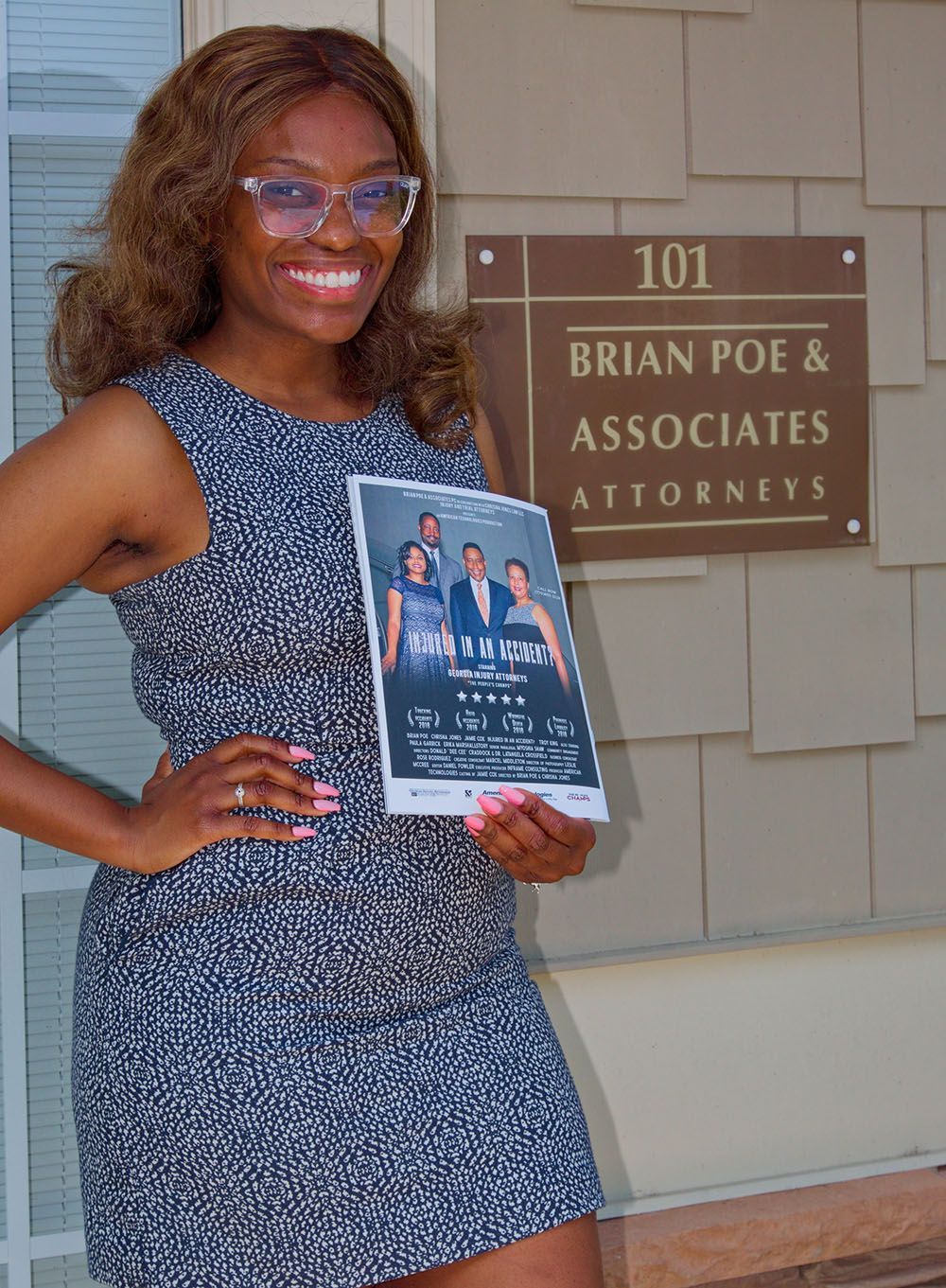 A client is holding a flyer in front of a building