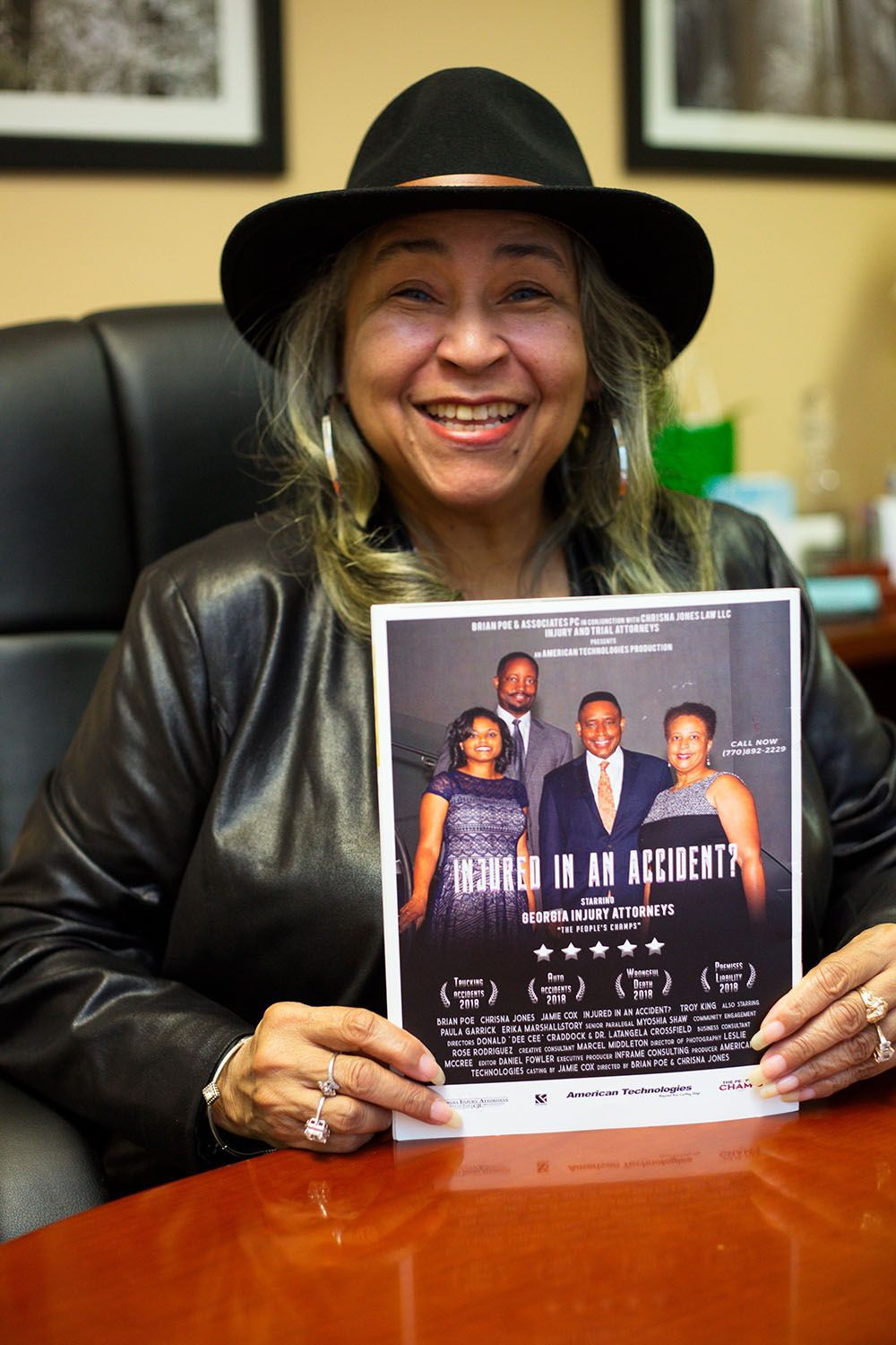 A woman in a hat is holding a flyer