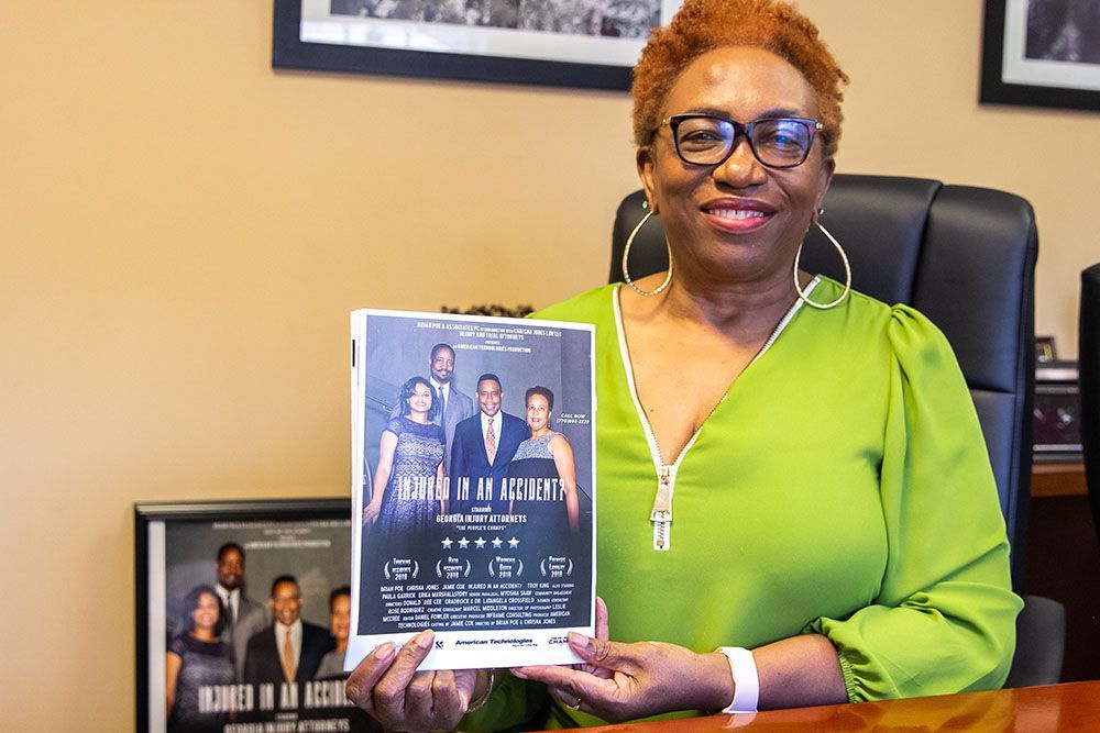 A woman in a green dress is holding a flyer