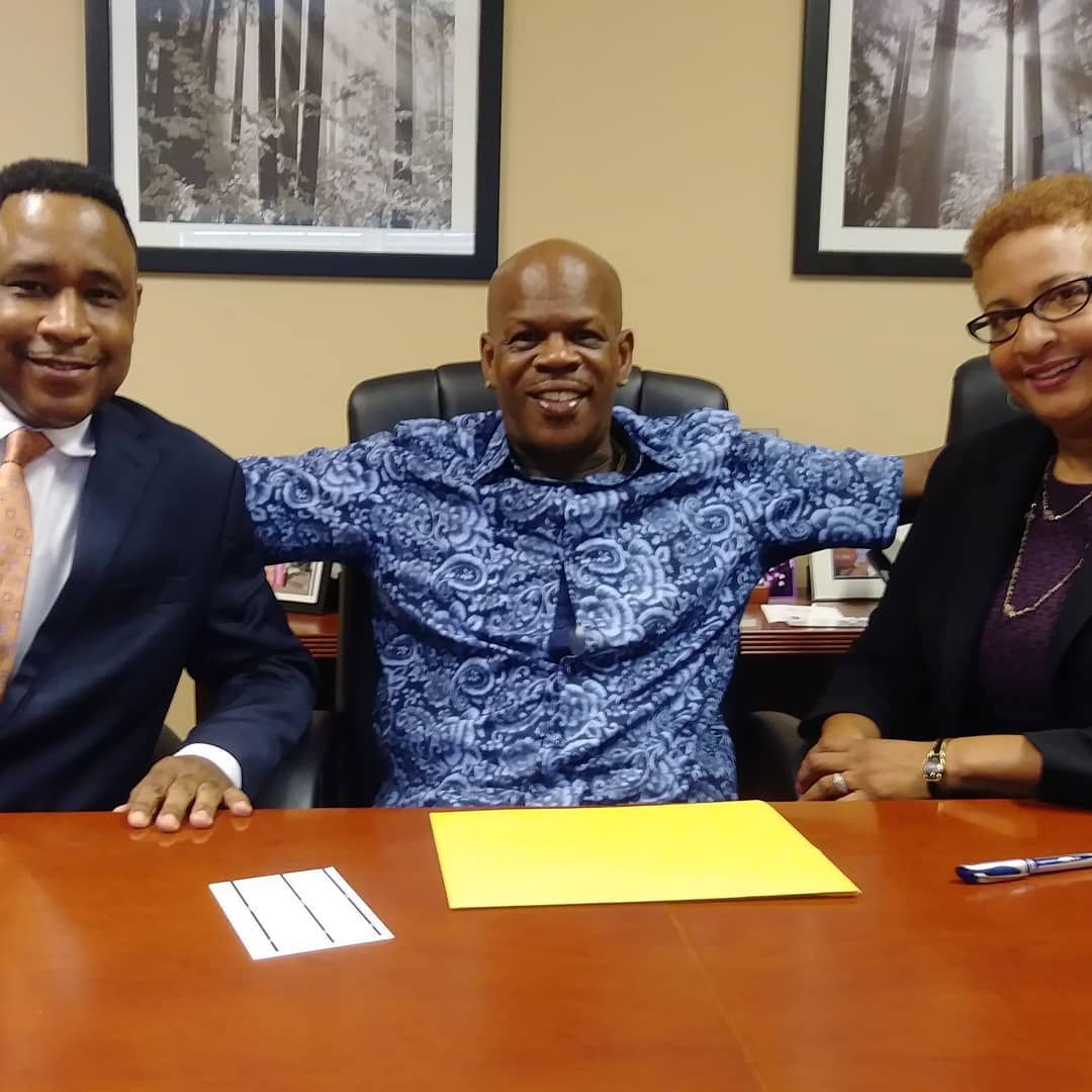 Brian D. Poe, Esq. with happy clients