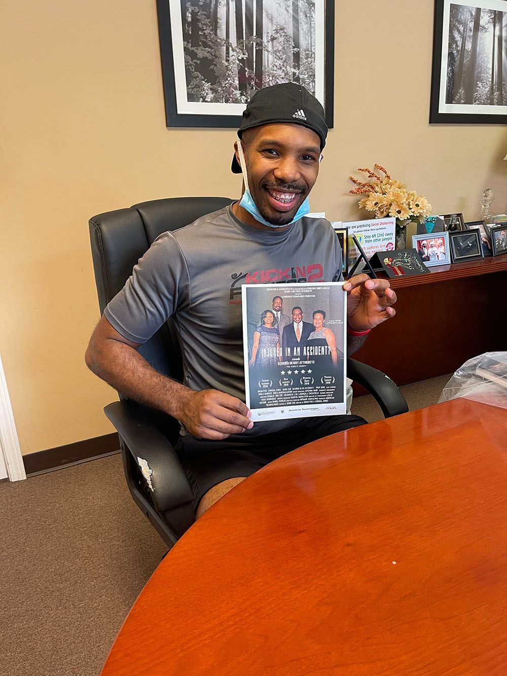 A man is sitting at a table holding a flyer