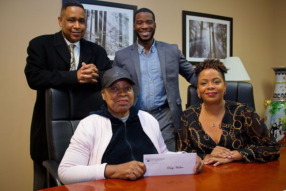 A group of people are posing for a picture while sitting at a table