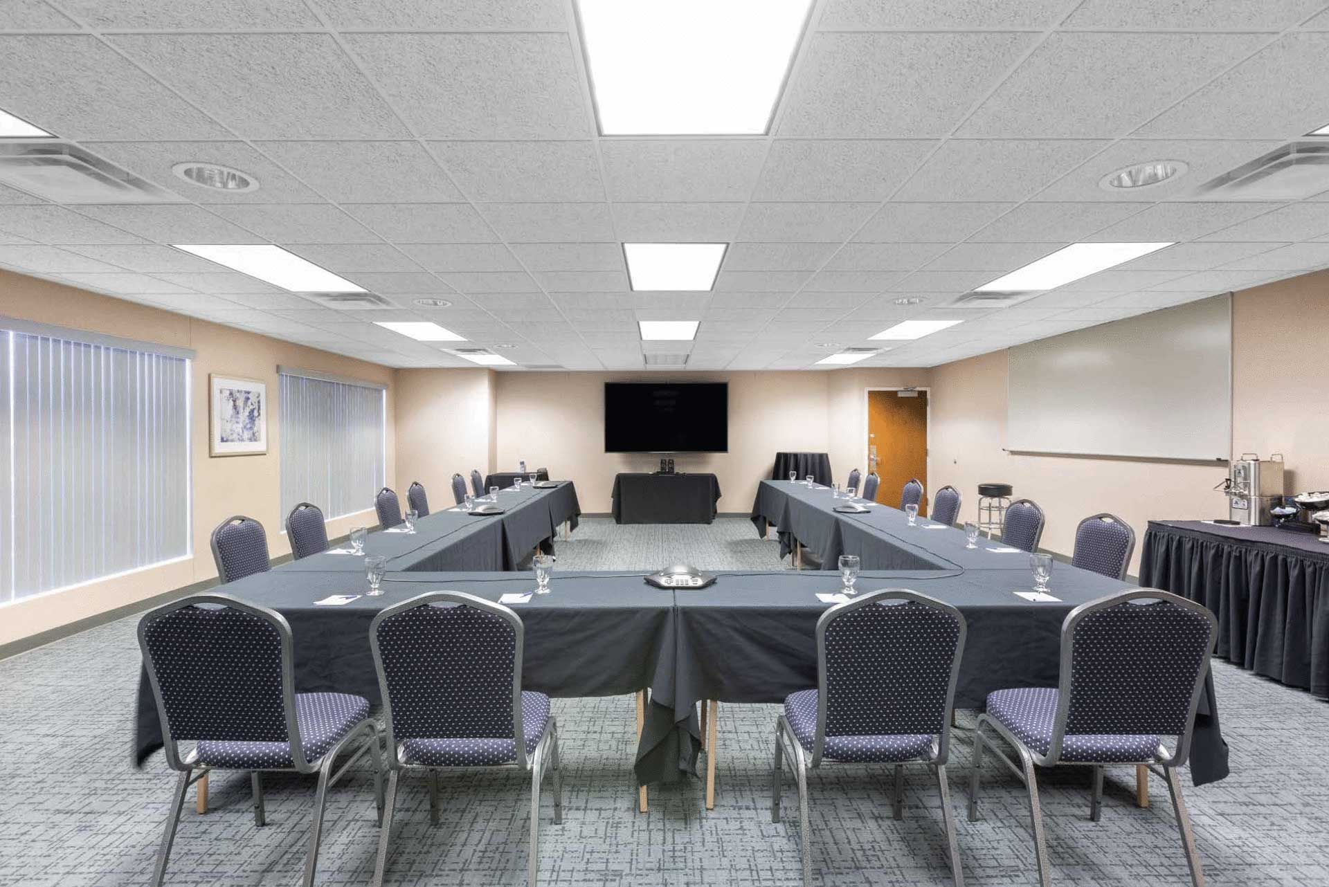 A large conference room with tables and chairs set up for a meeting.
