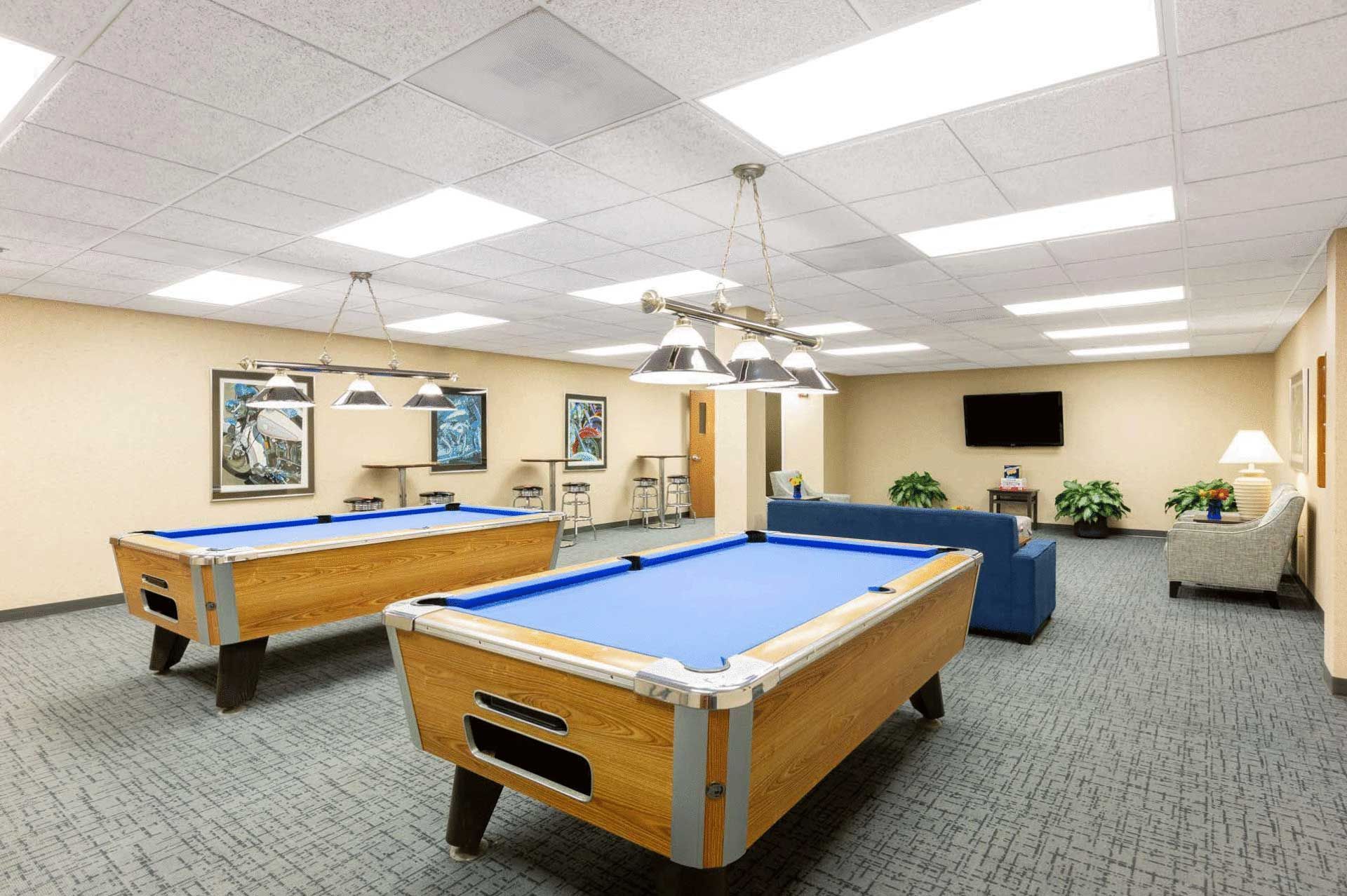 There are two pool tables in the room.