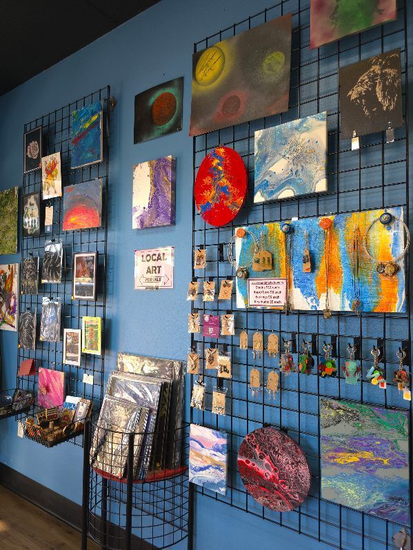 A blue wall with a lot of paintings on it