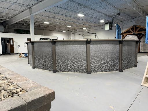 Indoor showroom with a large octagonal stone bar and concrete floor