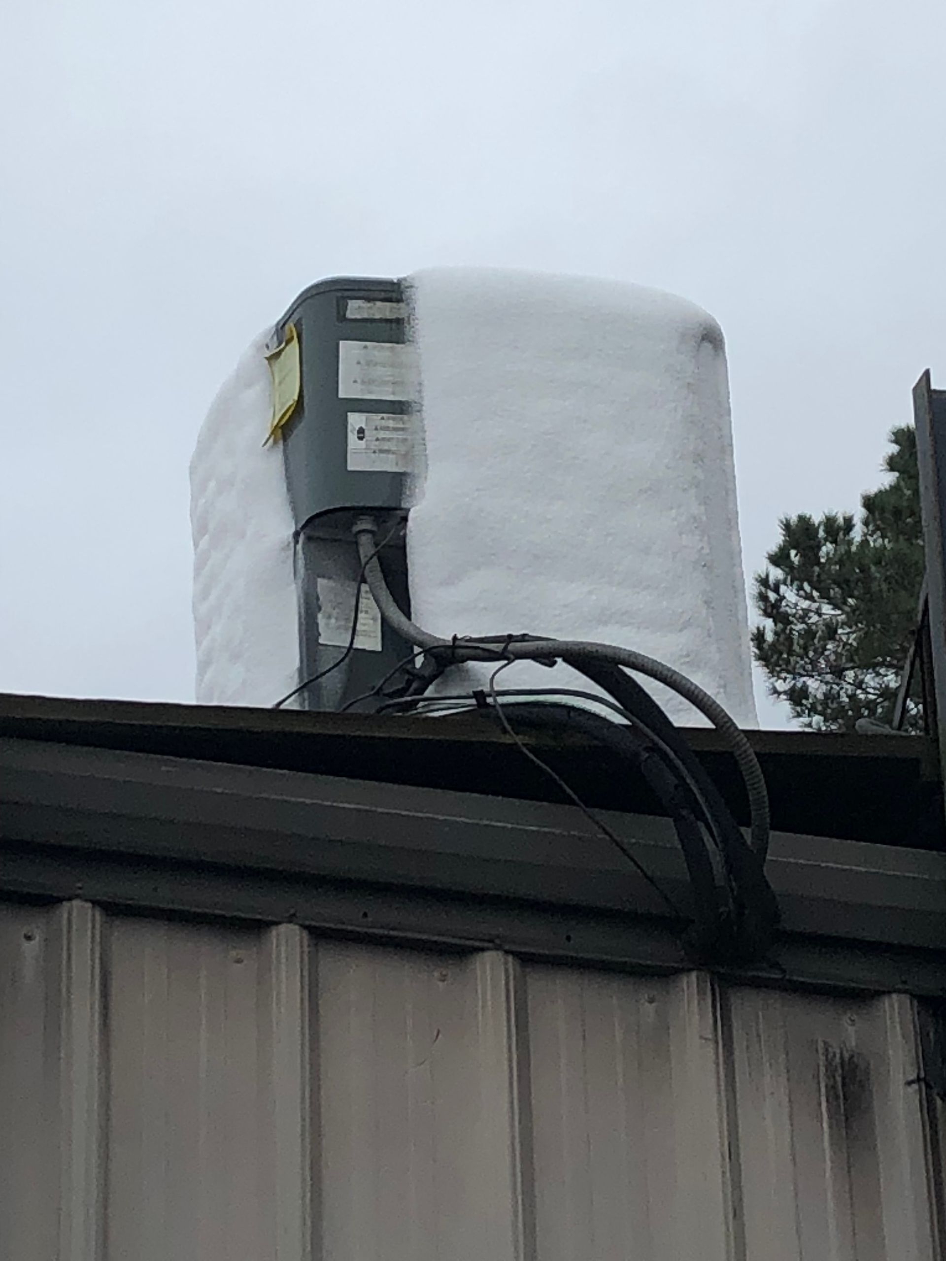 a large piece of snow is sitting on top of a building