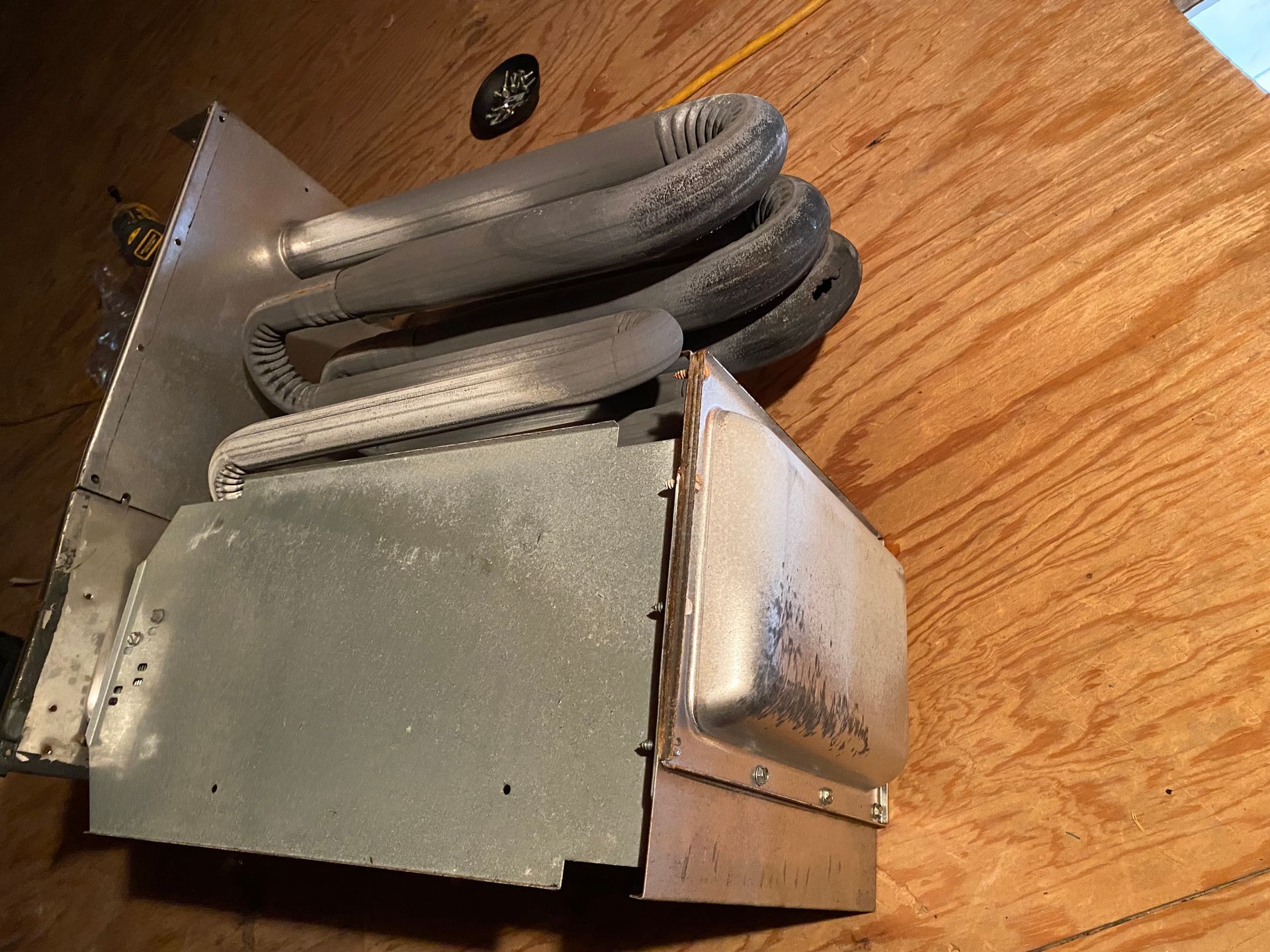 a piece of metal is sitting on top of a wooden table