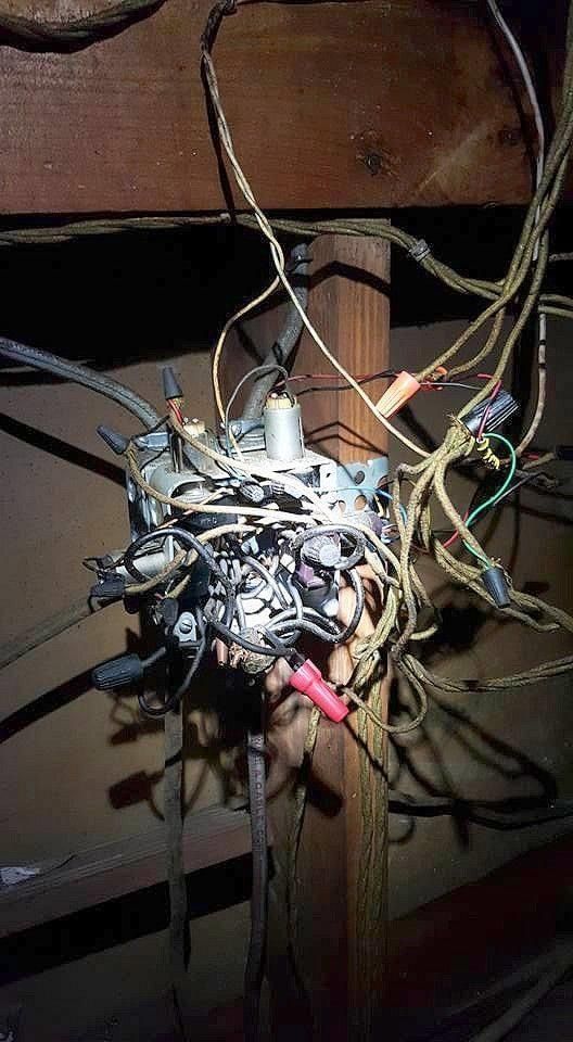 a bunch of wires are hanging from the ceiling of a building 
