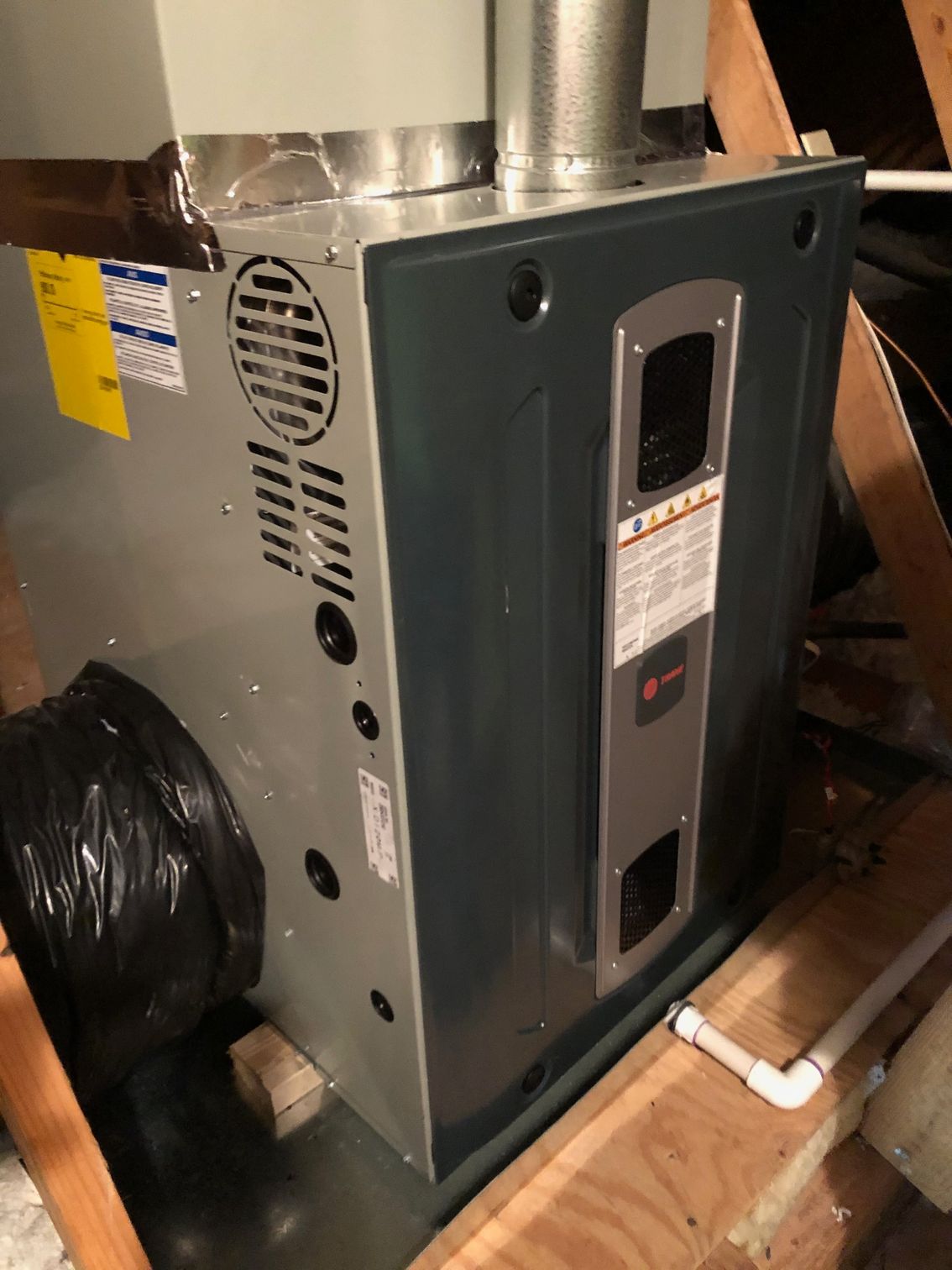 a furnace is sitting on top of a wooden box