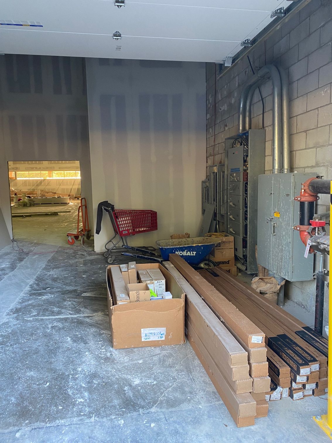 a warehouse filled with boxes and a shopping cart