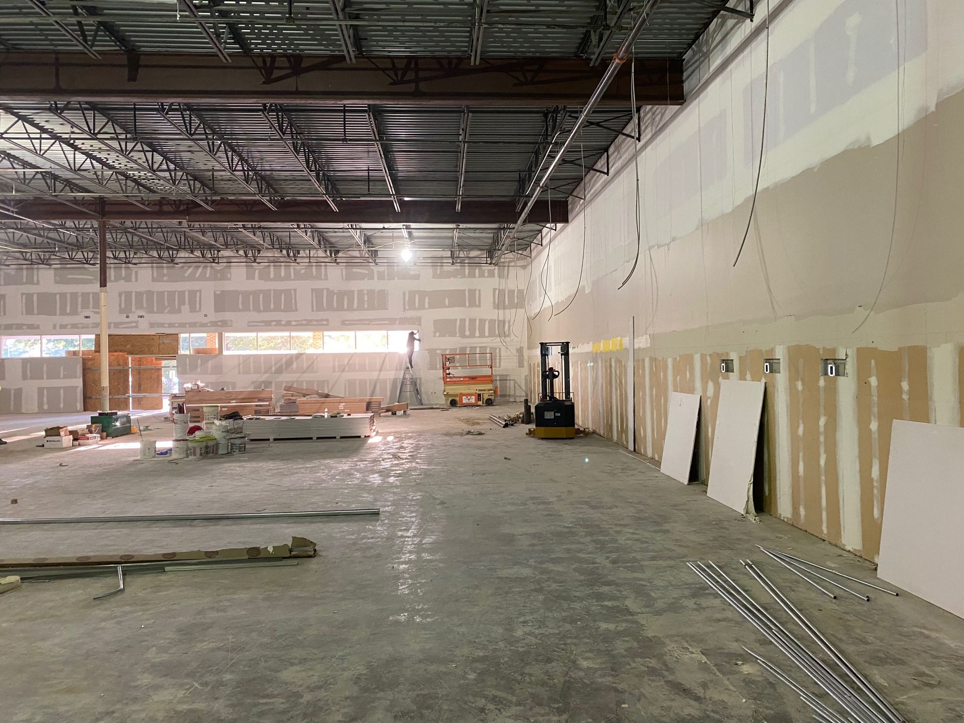 a large empty building with a forklift in the middle