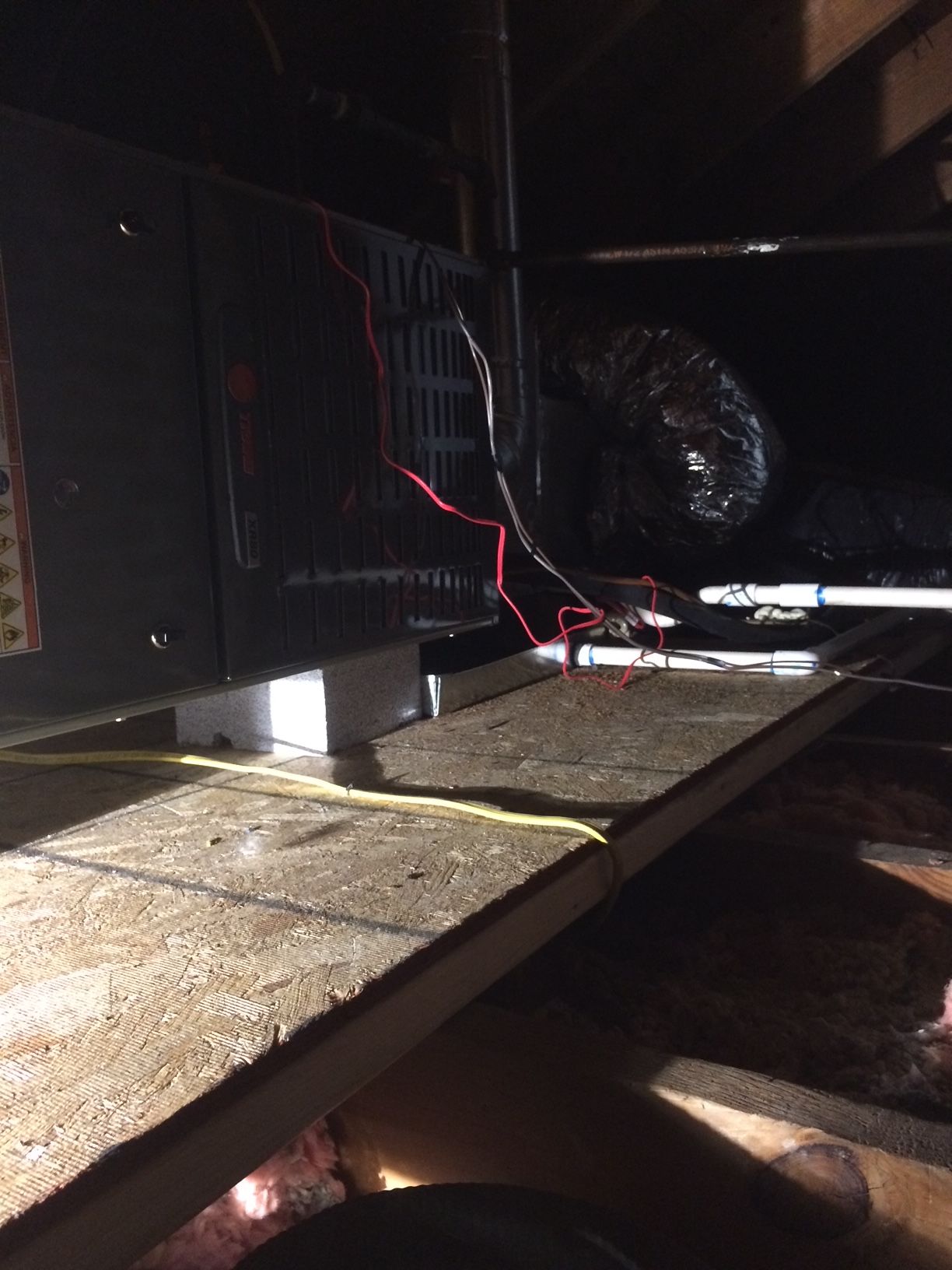 a black box is sitting on a wooden floor in a dark room 