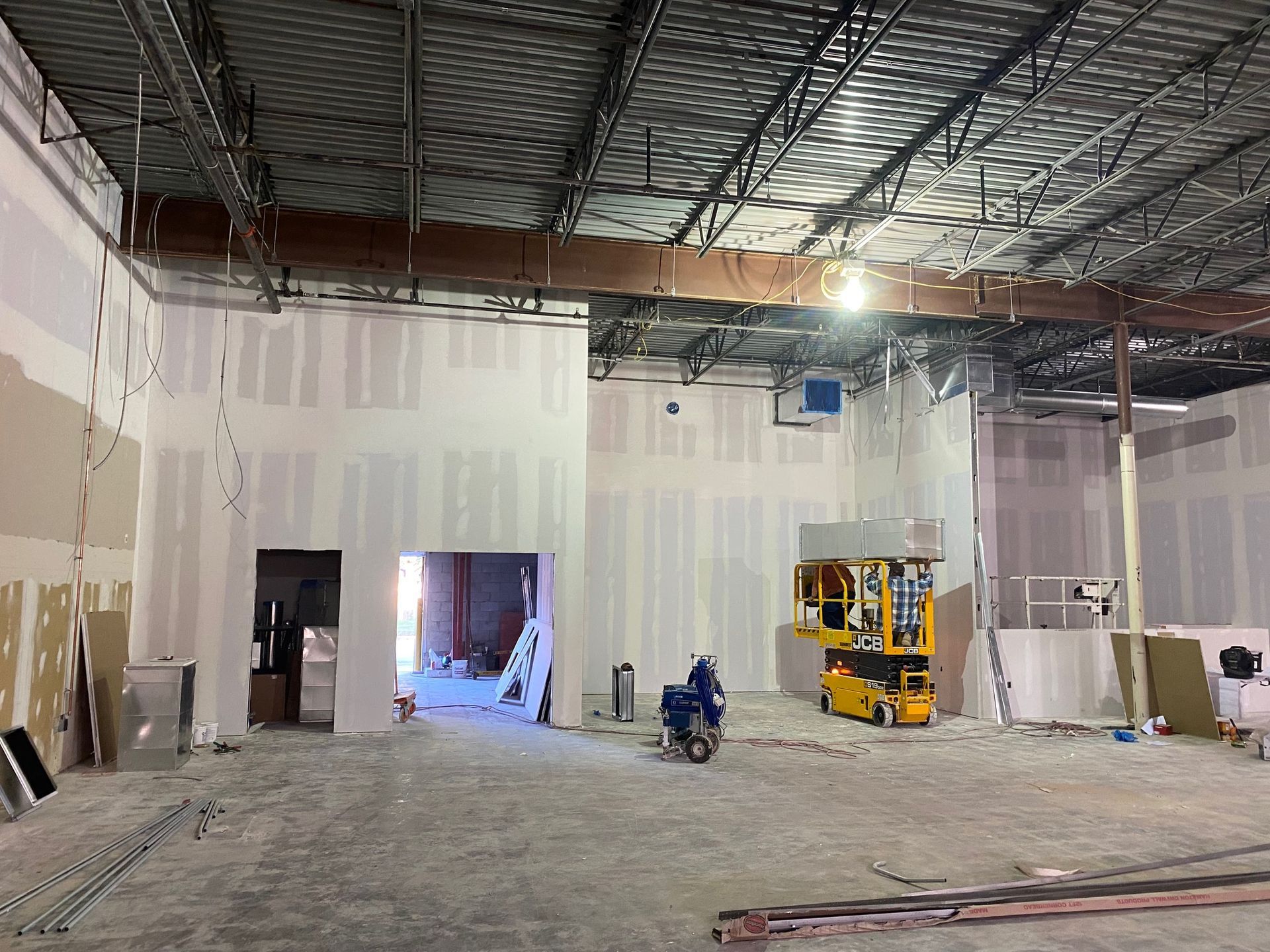 a large empty room with a ceiling that is being built