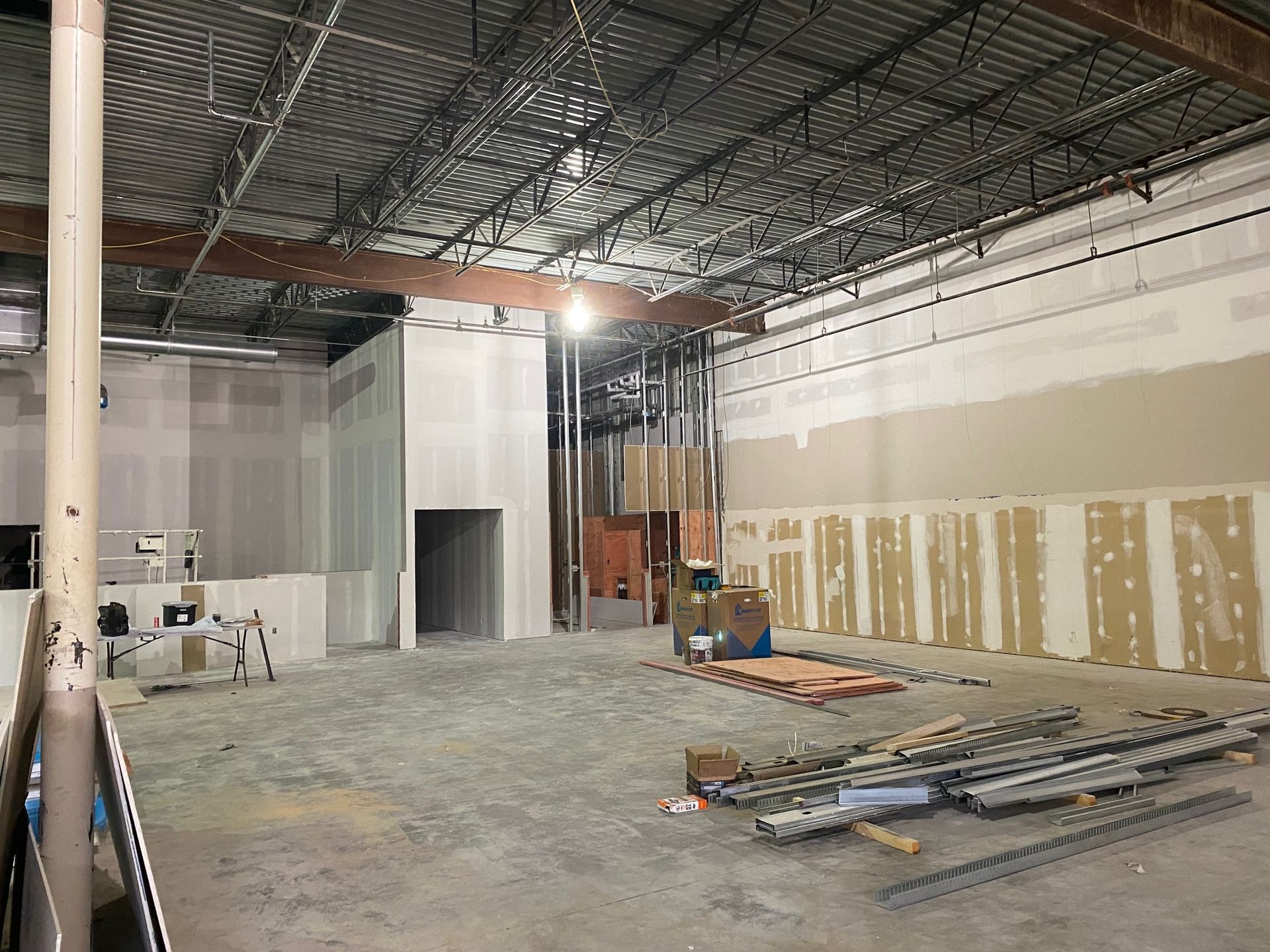 the inside of a building under construction with a lot of boxes on the floor