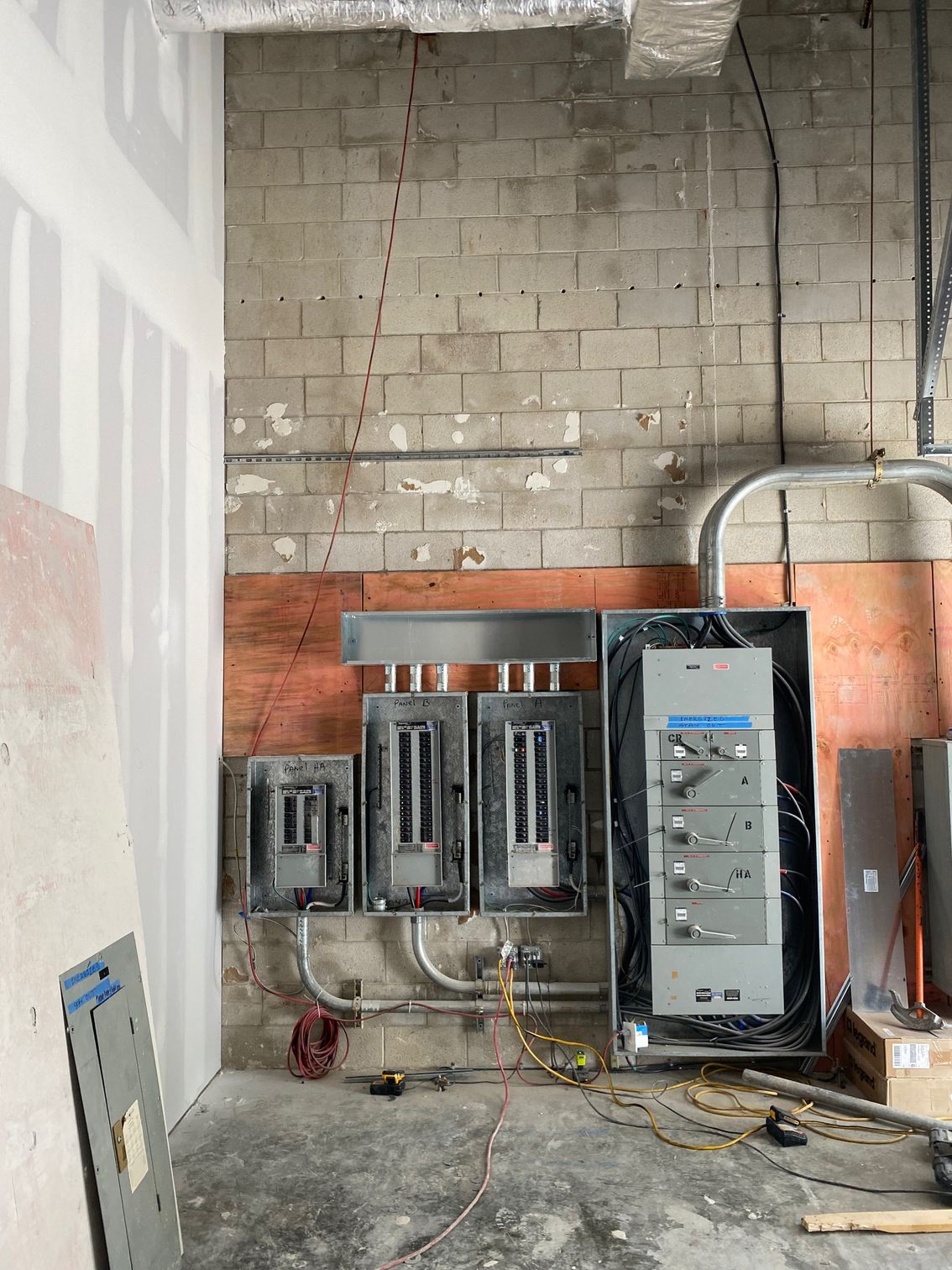 a room with a brick wall and electrical panels on it