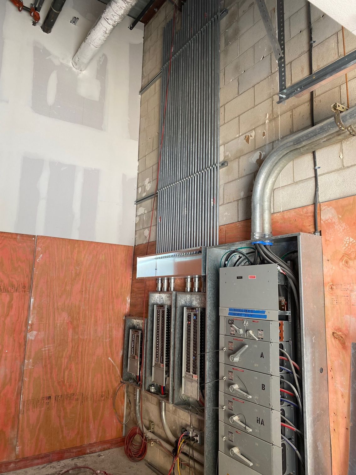 a room with a lot of electrical wires hanging from the ceiling