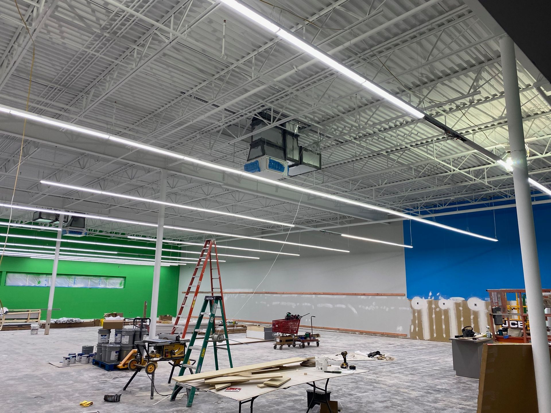 a large building under construction with a green screen in the background