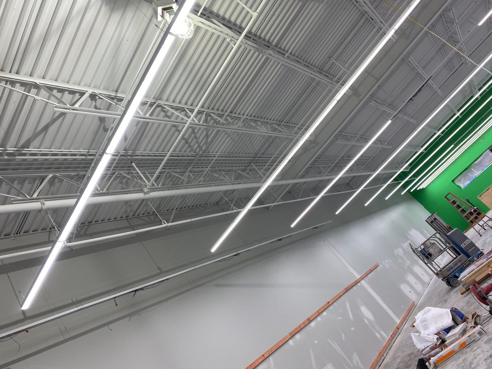 a large room with a lot of lights hanging from the ceiling