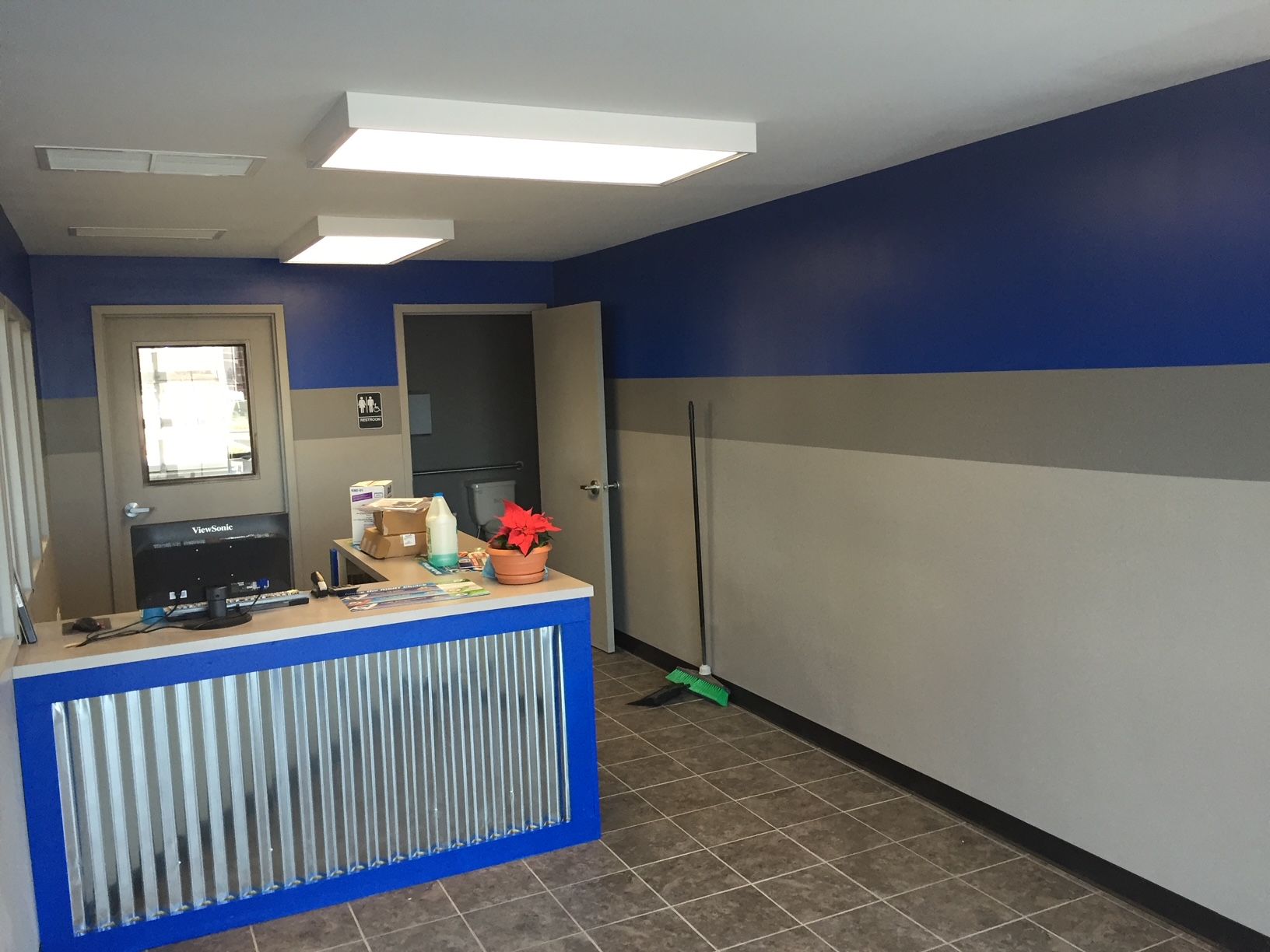 a room with blue and white walls and a metal counter