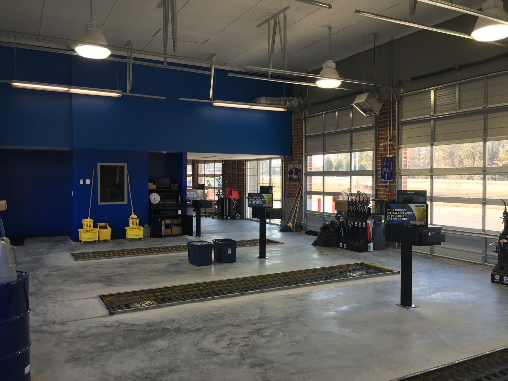 a garage with a lot of windows and a blue wall
