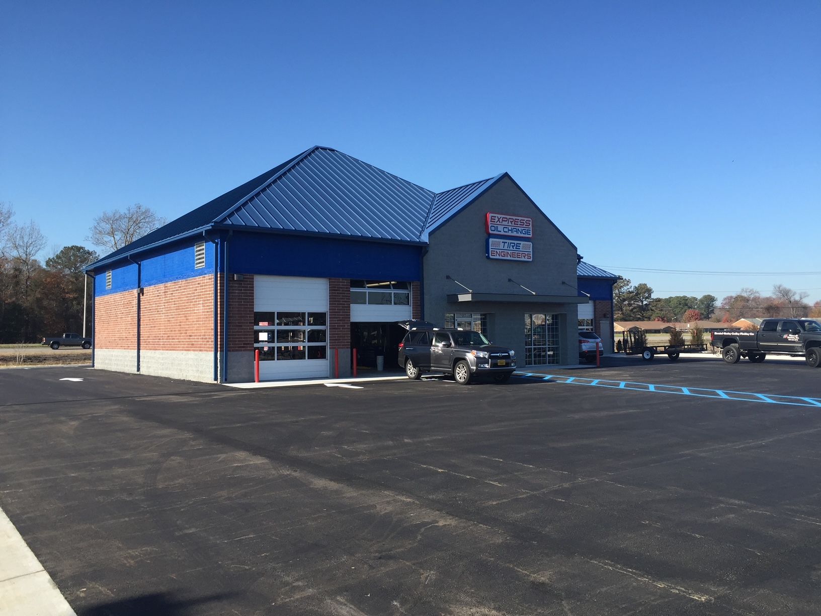 a car is parked in front of a building with a blue roof