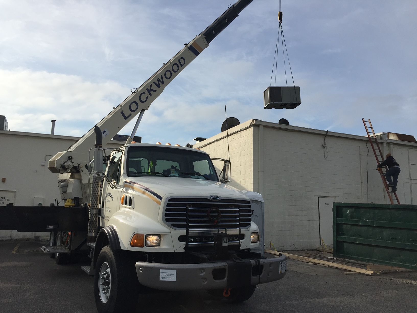 a truck with a crane attached to it that says lockwood