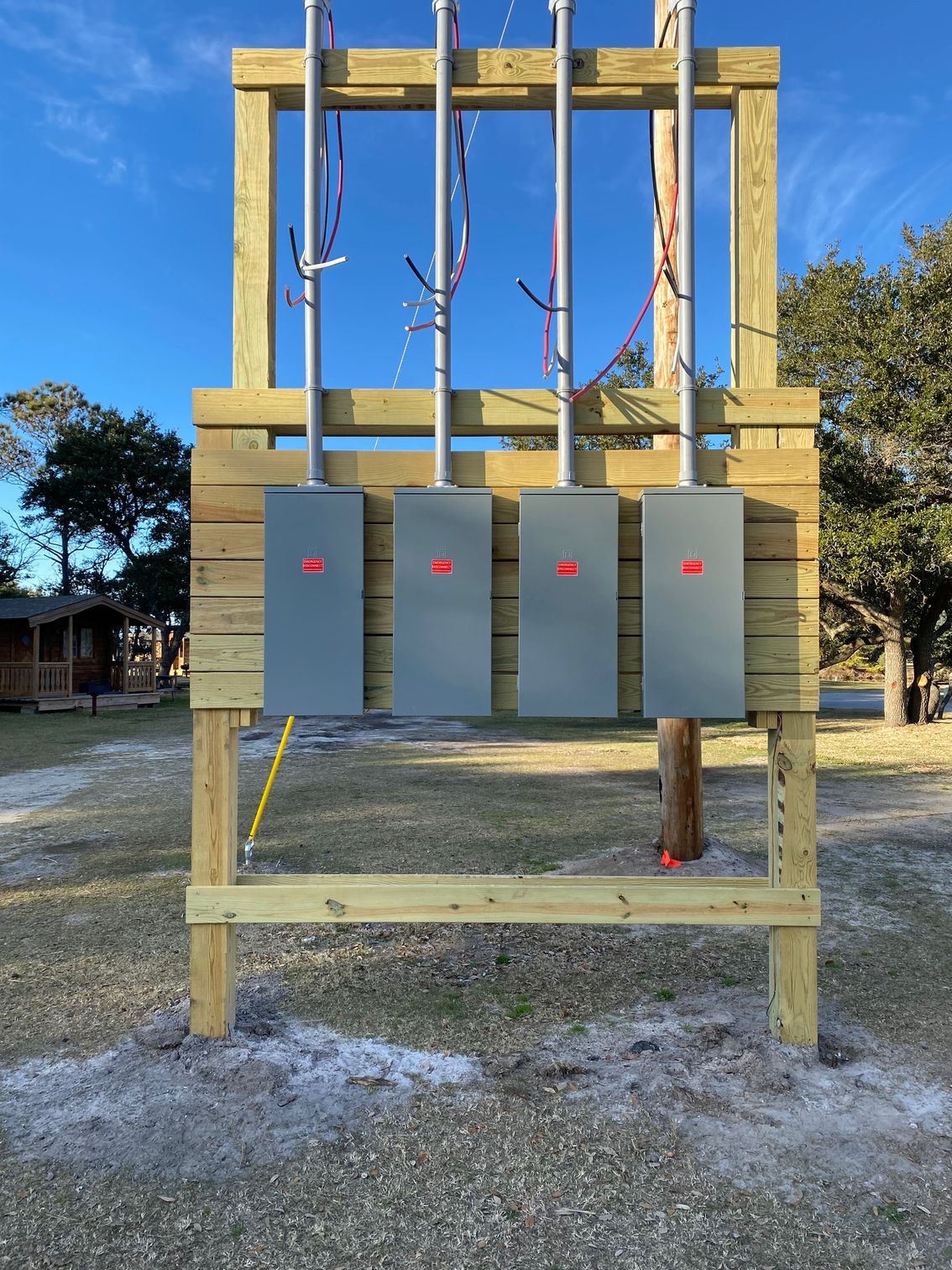 a wooden structure with four electrical boxes on it