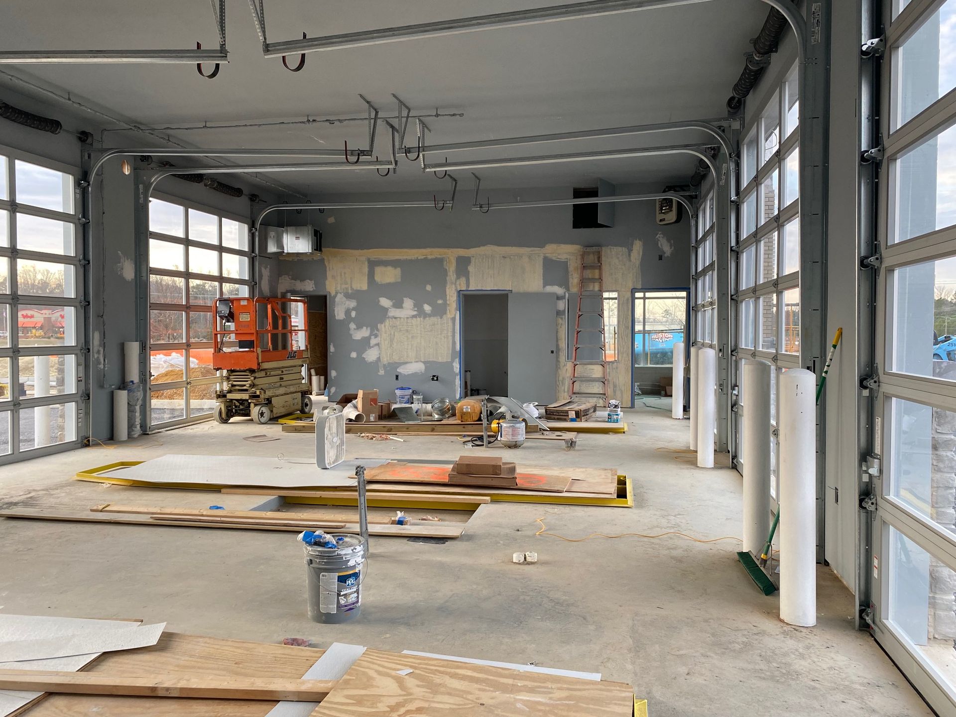 a large room with a lot of windows is being remodeled