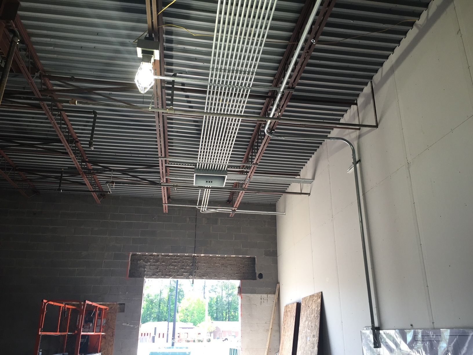 a ceiling with a lot of wires hanging from it