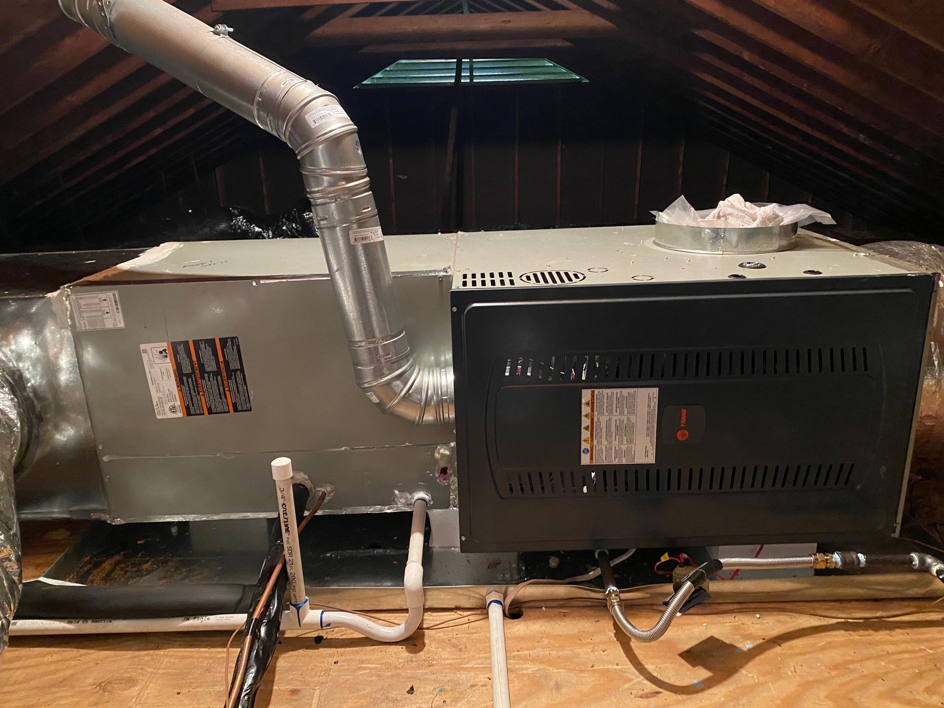 a large air conditioner is sitting in the attic of a house