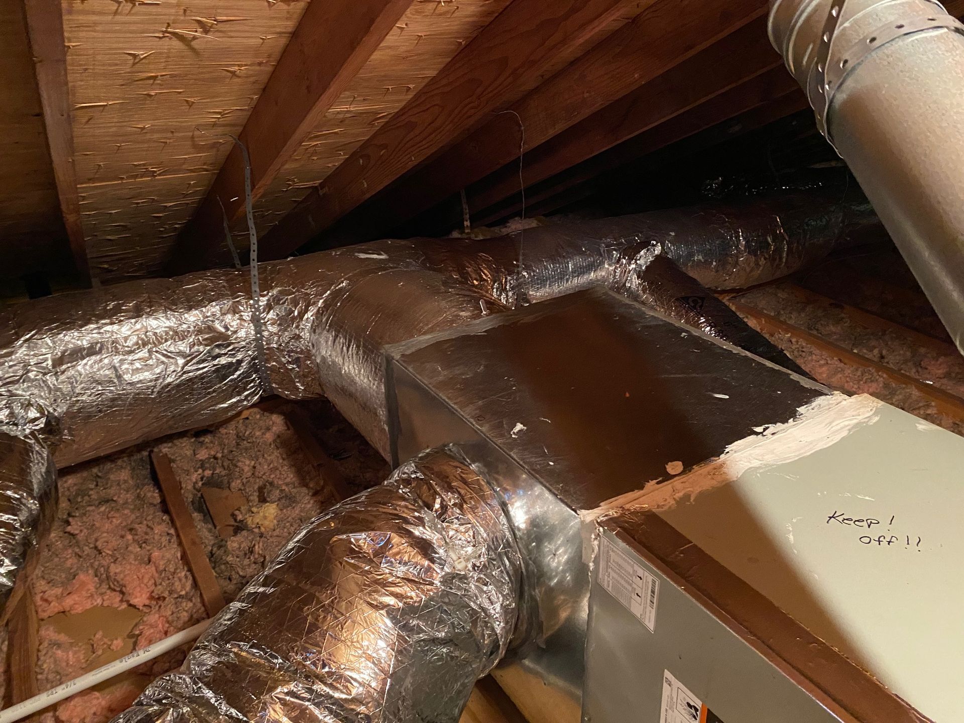 a bunch of pipes are hanging from the ceiling of a room