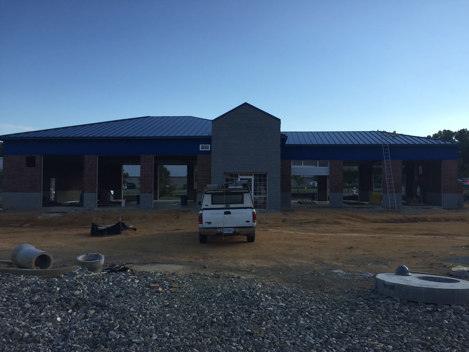 a white truck is parked in front of a building under construction 