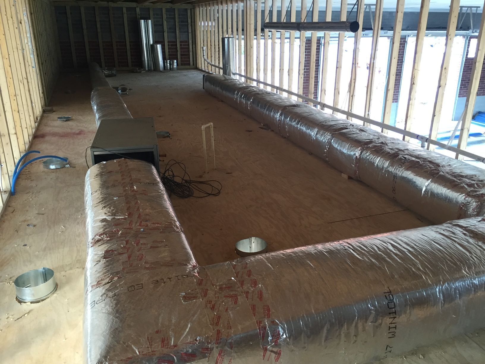 a room with a lot of ducting on the floor