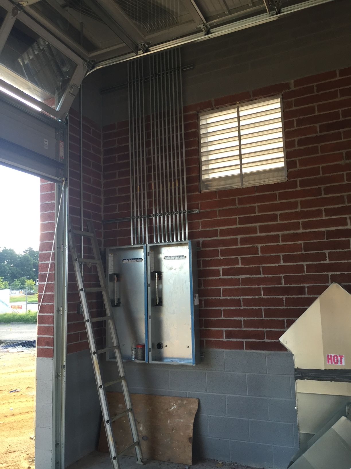 a ladder is leaning against a brick wall in a garage